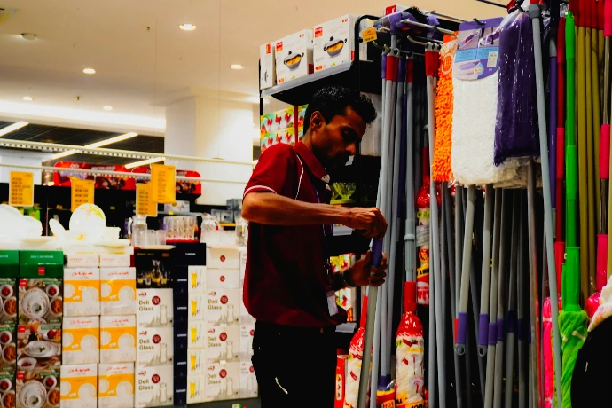 Man arranging cleaning supplies in a store